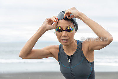 Triathlete woman coming out from sea